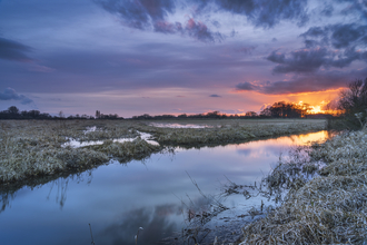 A glowing sunrise over Wheldrake Wetlands. Photograph by John Potter