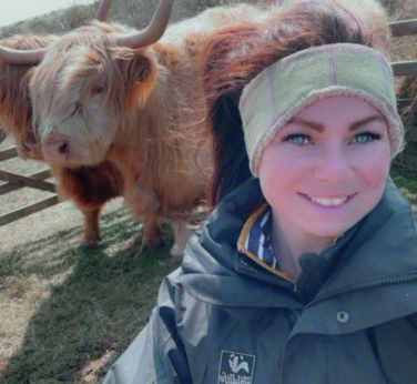 Selfie of our Grazing Manager, Charlotte Dring with two Highland cows.
