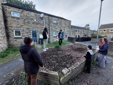 Group of youths gardening in an urban, residential area, helping the community