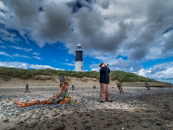 Man with binoculars at Spurn Lighthouse