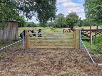 A brand new light wood gate looks out over the golf course