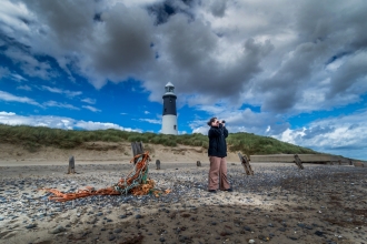 Man with binoculars at Spurn Lighthouse