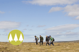 Group walking across moorland with 'wildest' symbol