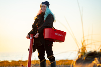 Staff member with seagrass planting equipment