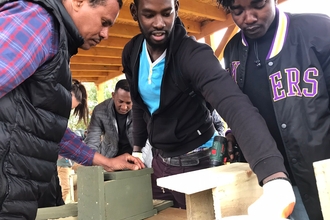 The Welcome to English team building a nest box. Photo by Karen van Diesen