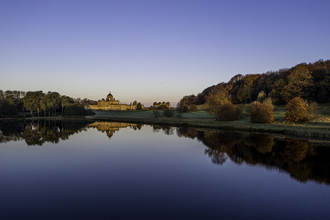 Image of Castle Howard seen from across lake at dusk