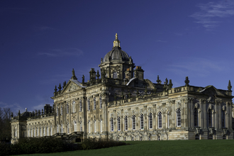 Image of Castle Howard with blue sky and grass
