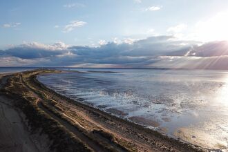 Image showing sun coming up behind clouds onto Spurn Point