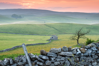 A crimson sunrise over the rolling hills of Ashes Pasture