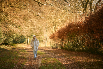 Woman walking in an autumnal woodland