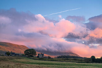 A pink sunrise over Ingleborough mountain