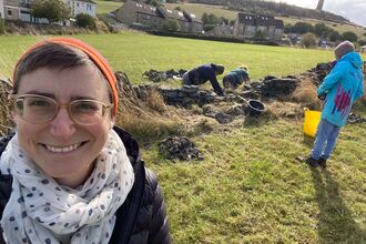 Suzannah Rockett YWT trustee in front of dry stone walling