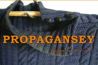 Image of a knitted blue gansey with the logo for Propagansey in orange over the top