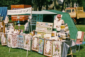 Margaret Hartley at a show selling YWT merch 1976-early 80s tent & banner - Borthwick Institute for Archives