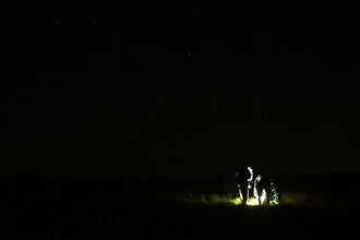 lantern lit people in the dark