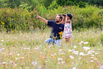 Man and child watching wildlife