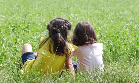 Girls sitting in a meadow
