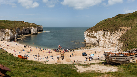 A sunny landscape photograph of the beach at Flamborough Cliffs