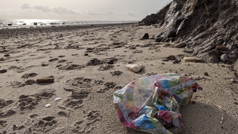 beach litter strewn across a beach.