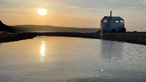 Sauna tent on a beach at sun set