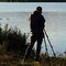 Jono with binoculars looking over lake