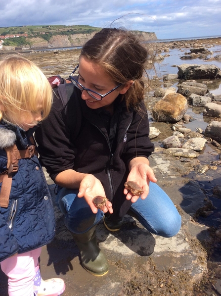 An image of Ana, Marine Pollution Officer, with a little girl.