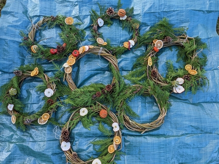 Image of willow wreaths on blue tarpaulin