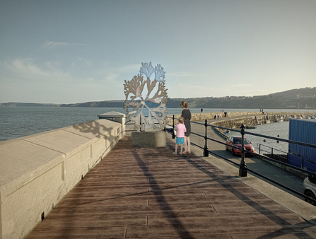 Proposed Seaweed Sculpture on Scarborough harbour. View of a boardwalk and two people looking at it.
