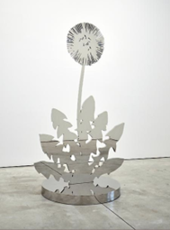A metal sculpture of plant leaves on the bottom and single stem shooting out with a round head.