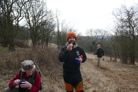 Elliot from the INNS team eating cake on site