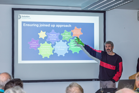 Jon Traill presenting at the Wolds Discovery day, screen reads 'ensuring a joined up approach'