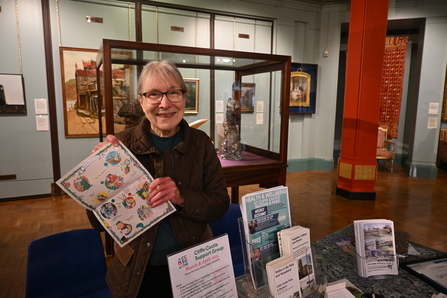 Cliffe Castle Supporter Group stand with woman holding a poster