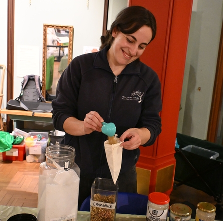 Woman scooping bath salts into a bag