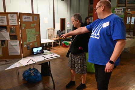 Man pointing at an information stand