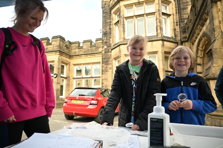 Action for Nature stalls with woman and 2 children