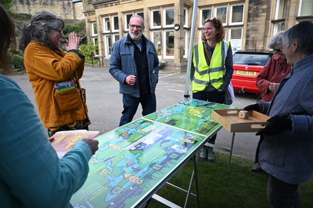 People standing around giant board game