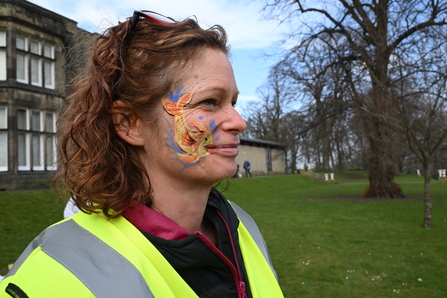 Woman with face paint of a fish