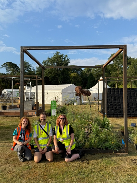 Photo showing the Hoverfly Haven design team sat in front of the garden.