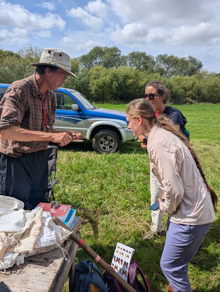 Student watching bird ringer working