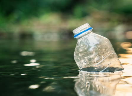 Plastic bottle floating in river