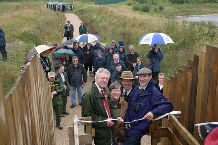 People cutting a ribbon at the opening of North Cave Wetlands 