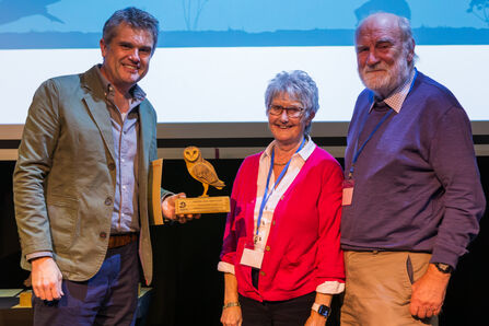 Gill and Rick Battarbee (R) accept an award from Wildlife Trusts CEO Craig Bennett (L)