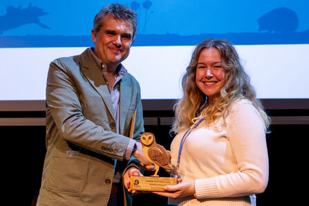 Katie Andrews (right) accepts an award from Wildlife Trusts CEO Craig Bennett (left)