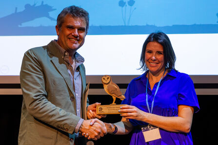 Kerry Thompson, right, accepts an award on behalf of Wyke 6th Form College from Wildlife Trusts CEO Craig Bennett (left)