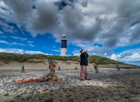Man with binoculars at Spurn Lighthouse