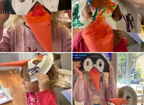 Kids wearing homemade puffin masks, made from paper plates.