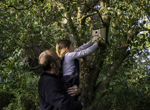 A father and daughter put up a bird box