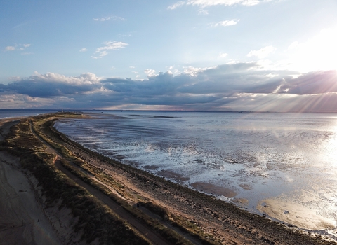 Image showing sun coming up behind clouds onto Spurn Point